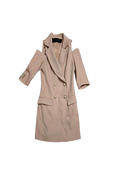 Front view of a double-breasted beige coat with wide lapels.