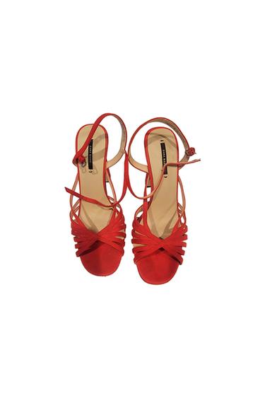 Red cross-strap sandals with a low heel and buckle closure. Visible label: "ZARA BASIC". White background.