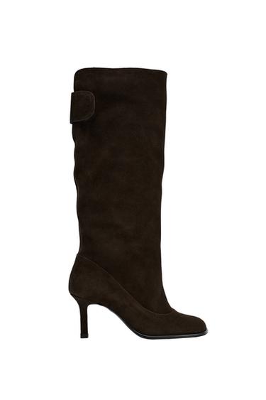 Side view of a brown high-heeled boot with buckle detail.