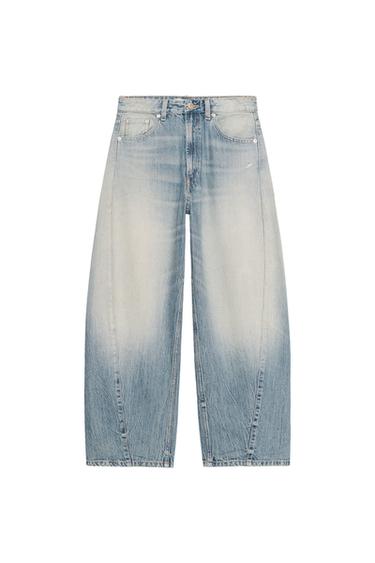 Front view of light blue wide-leg jeans with a faded effect and five pockets.