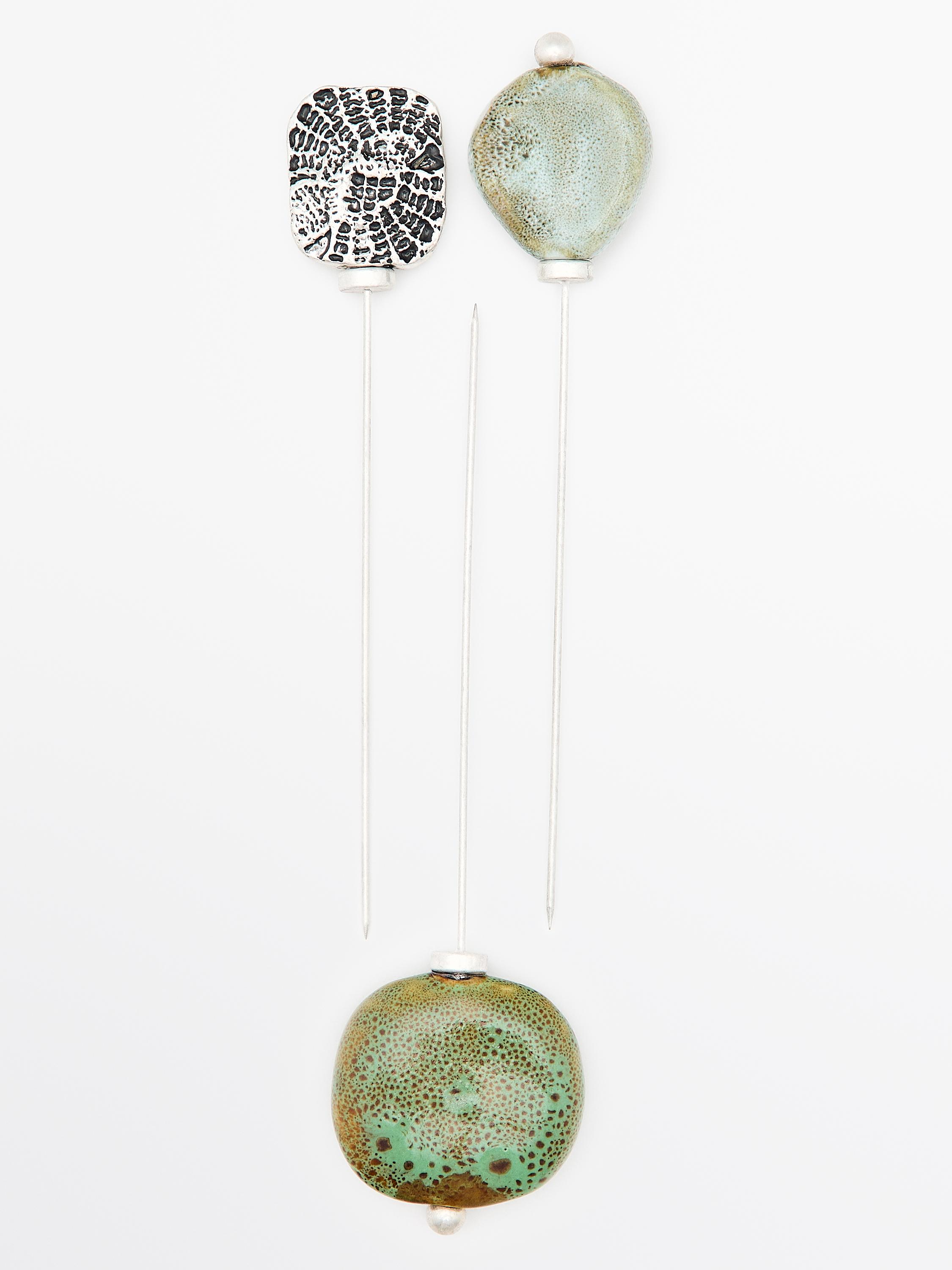 Brooch with textured ceramic piece and medallion