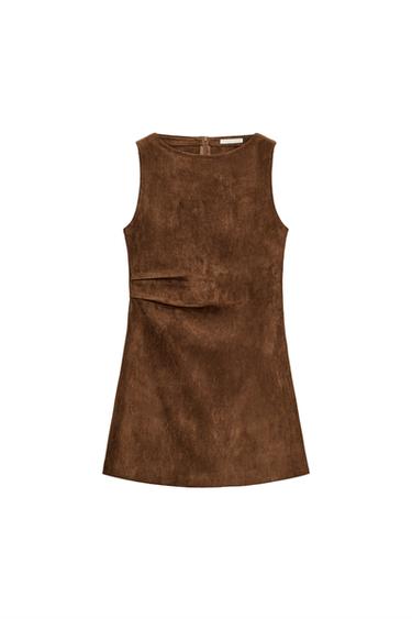 Front view of a sleeveless caramel-coloured mini dress with a round neck, side pleats, and a concealed back zip.