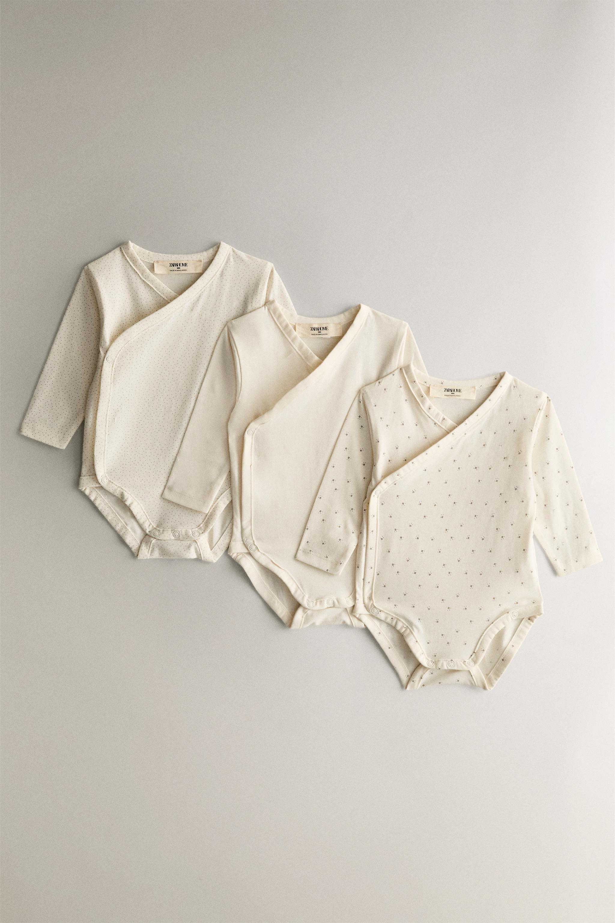 SET OF PRINTED BABY BODYSUITS