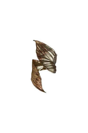 Gold ring with textured leaf design on a white background.