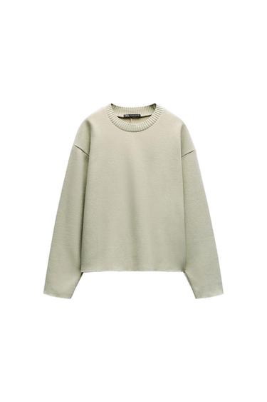 Light beige, long-sleeved, crew neck jumper on a white background. Label visible at the neck.