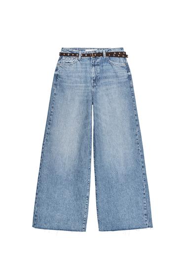 Front view of mid-blue, high-waisted, wide-leg cropped jeans featuring five pockets, belt loops, and a zip fly with button fastening.