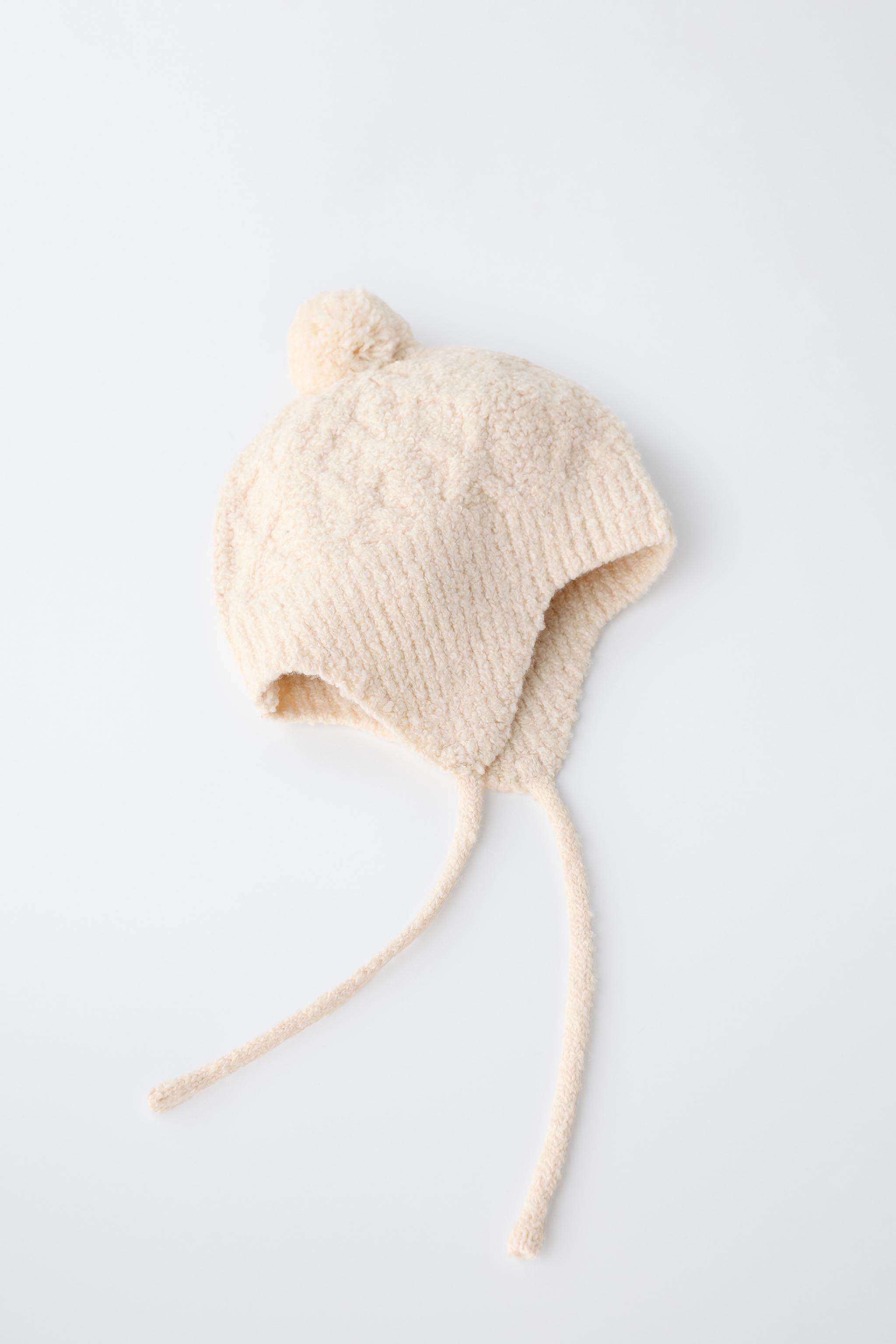 CABLE-KNIT POMPOM EARFLAP BEANIE