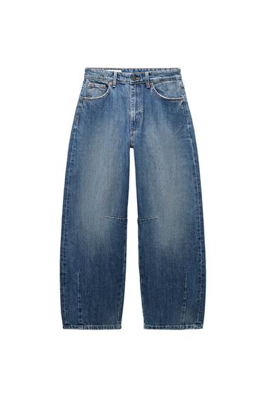 Front view of baggy blue jeans with five pockets and a front fastening with zip fly and metal button.