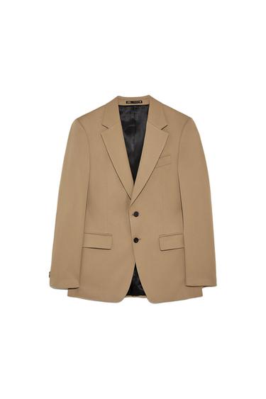 Front view of a beige jacket with lapels and two black buttons.