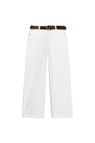 Front view of white, high-waisted, wide-leg, cropped jeans with five pockets, a brown belt, and a zip fly with button fastening.