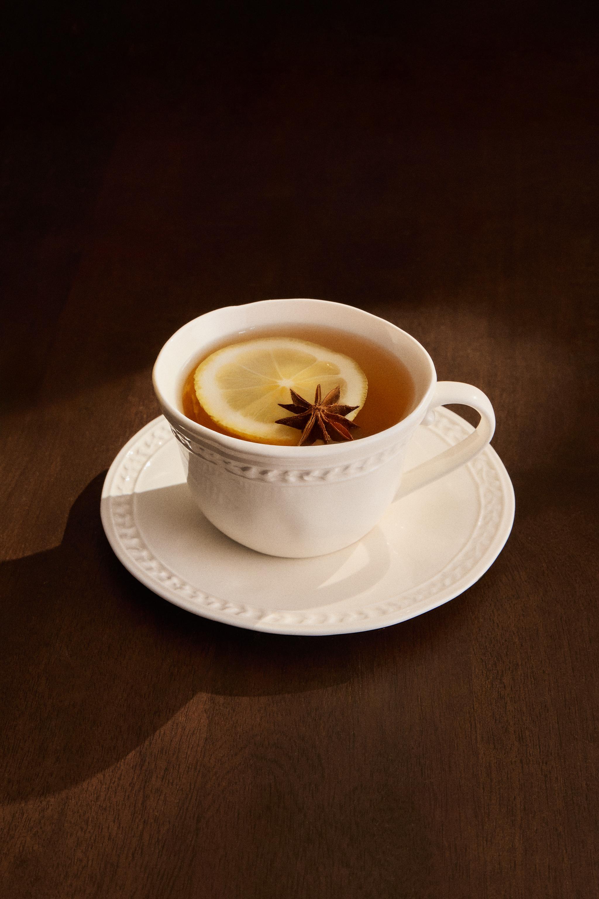 RAISED STONEWARE TEACUP AND SAUCER