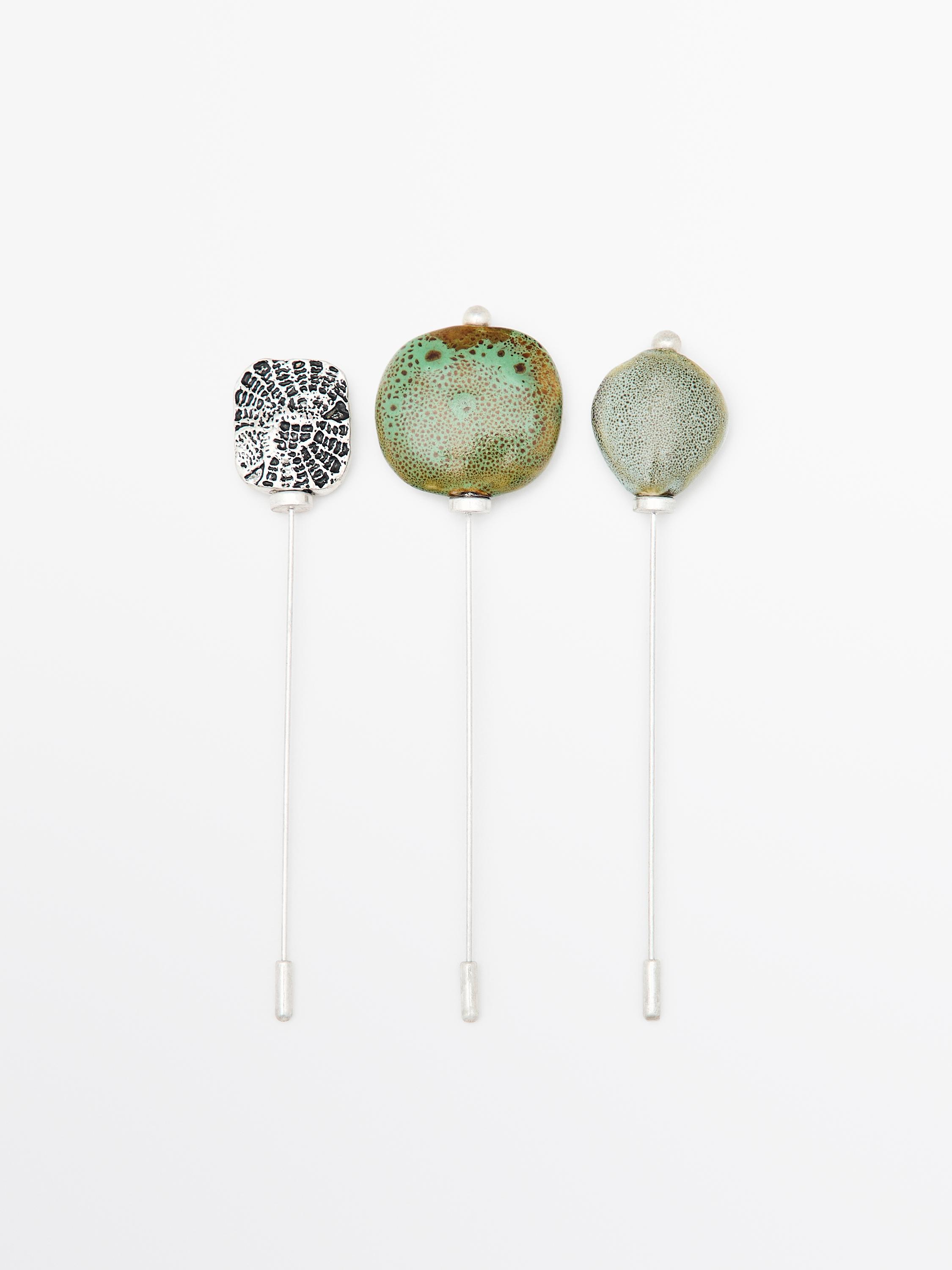 Brooch with textured ceramic piece and medallion
