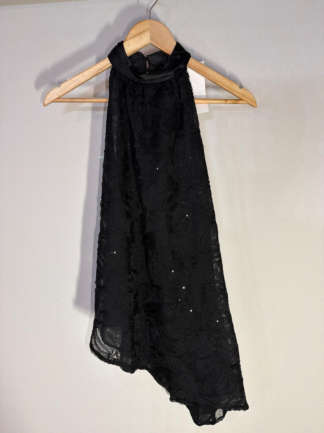 Sleeveless black roll-neck dress, hanging on a wooden hanger against a light background. Fabric with sparkly details.