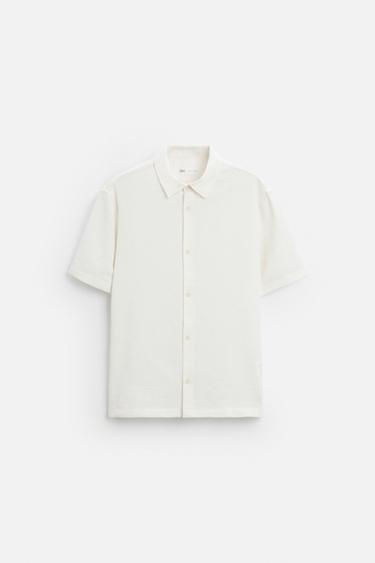 Zara Relaxed fit shirt made of cotton blend fabric. Lapel collar and short sleeves. Side vents at hem. Front button closure. - Ecru
