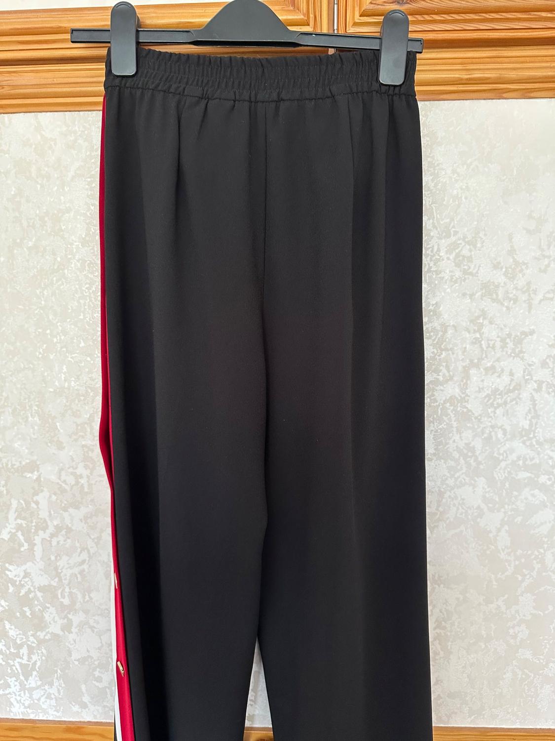 BLACK TROUSERS WITH RED AND WHITE SIDE STRIPES AND GOLD POPPER TRIM - Image 2