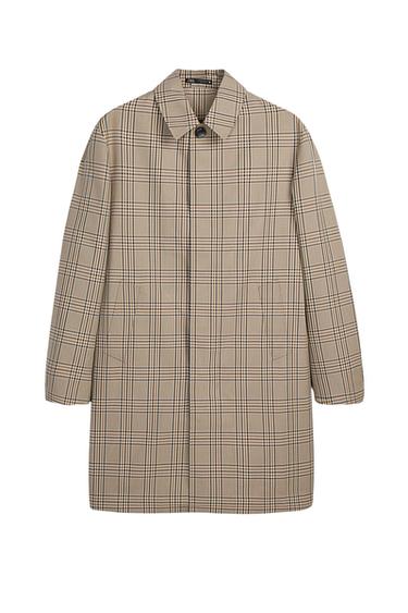 Beige coat with a checked pattern, classic collar, long sleeves and side pockets on a white background. ZARA label on the inside.