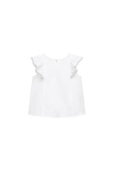 White round-neck top with frills on the shoulders and dark stitching detail on the trim, presented on a white background.