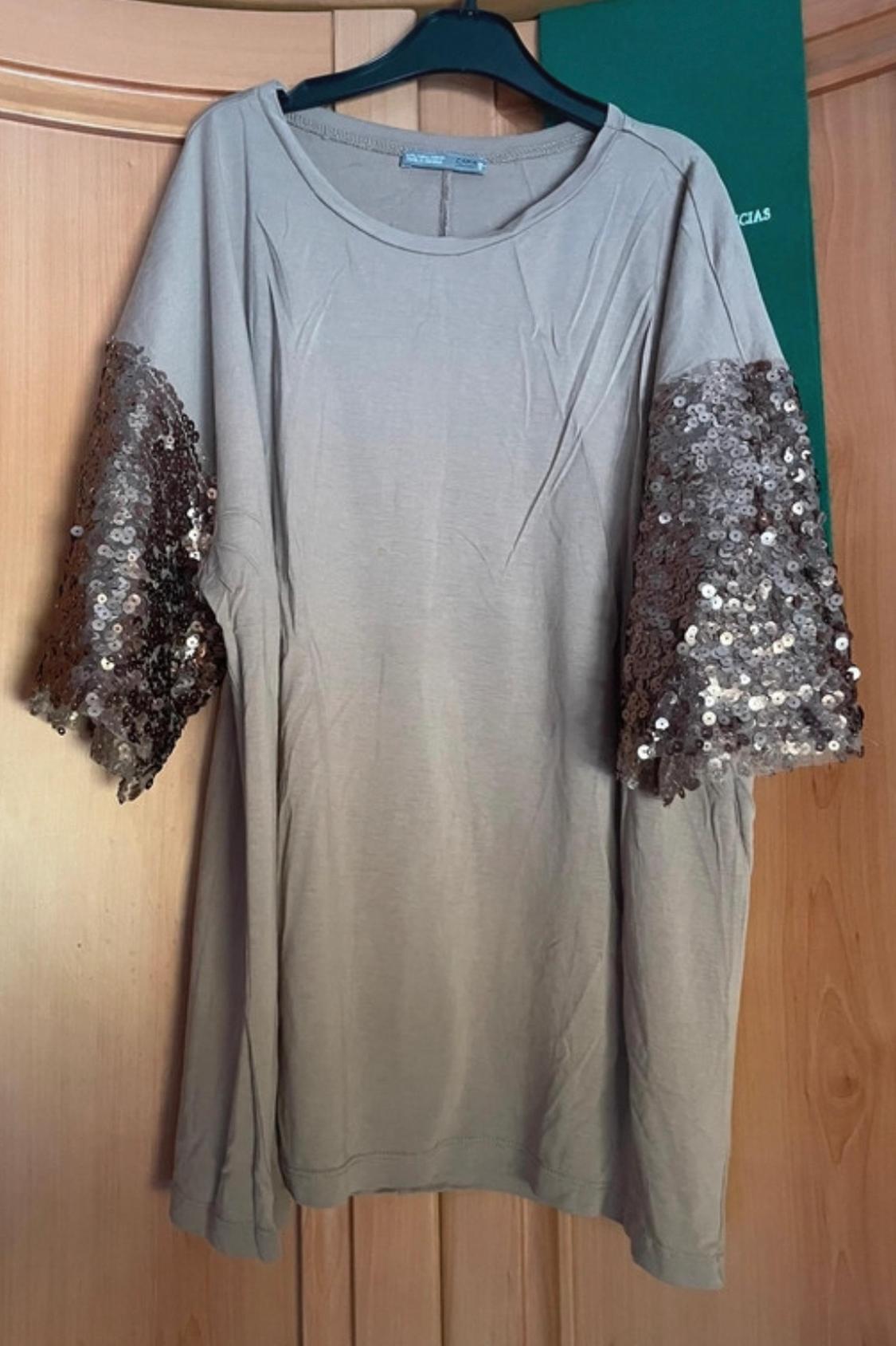 Front view of a beige t-shirt with sparkly sequin short sleeves