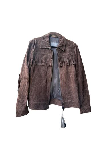 Brown jacket with fringe on the chest and sleeves. Front zipper closure and interior label with the text ZARA MAN. White background.