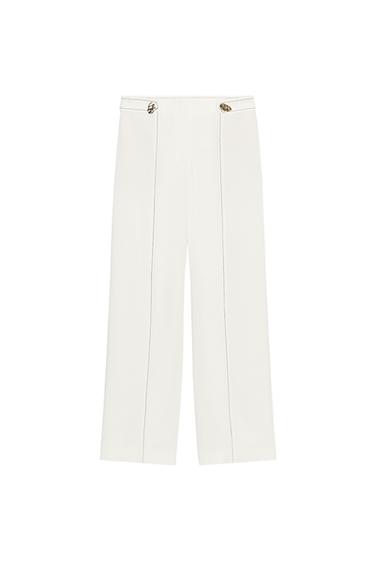 Front view of pants with gold buttons, contrasting topstitching, hidden side pockets, and a straight leg.