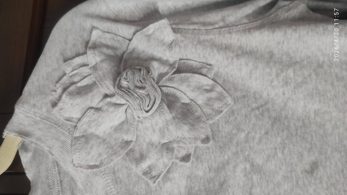 Grey T-shirt with fabric flower detail on the shoulder. Date in image: 2026/4/30 11:57.