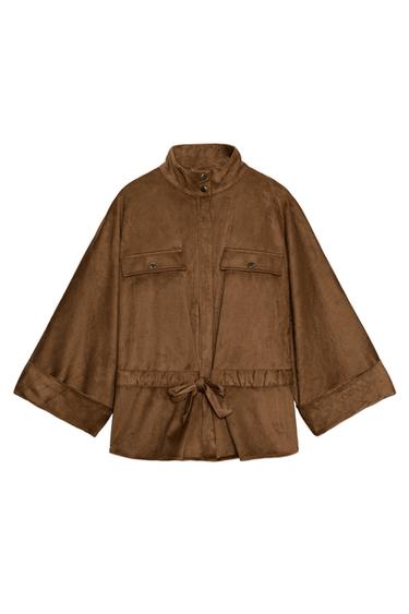 Front view of a light brown shirt with a stand-up collar, three-quarter sleeves, front pockets and an adjustable drawstring waist.