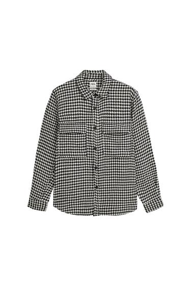 Front view of a black and white checked shirt with front pockets and buttons.