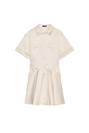 Front view of a beige dress with a classic collar, front flap pockets and centre button fastening.