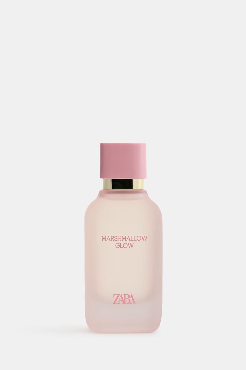 Perfume bottle with a pink cap and "MARSHMALLOW GLOW" text on the front. Minimalist and elegant design.