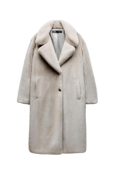 Front view of a long beige coat with wide lapels and side pockets.