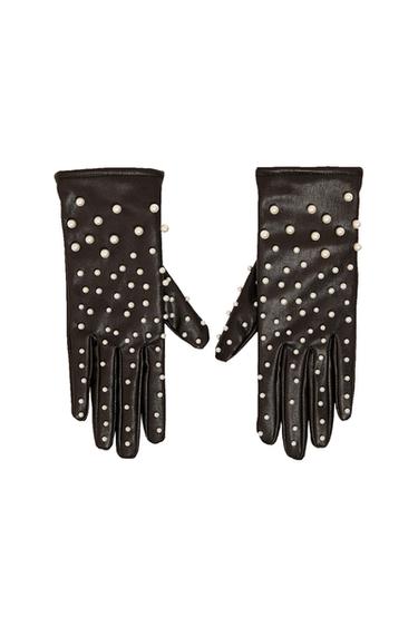 Pair of black gloves with white pearl embellishments, placed side by side against a white background.