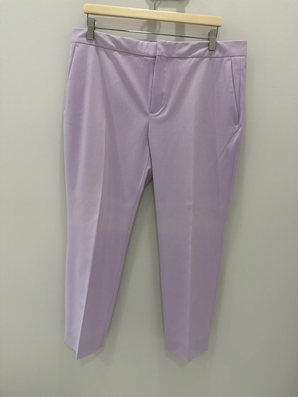 Lilac tailored trousers with a pronounced crease, hanging on a wooden hanger against a light background.