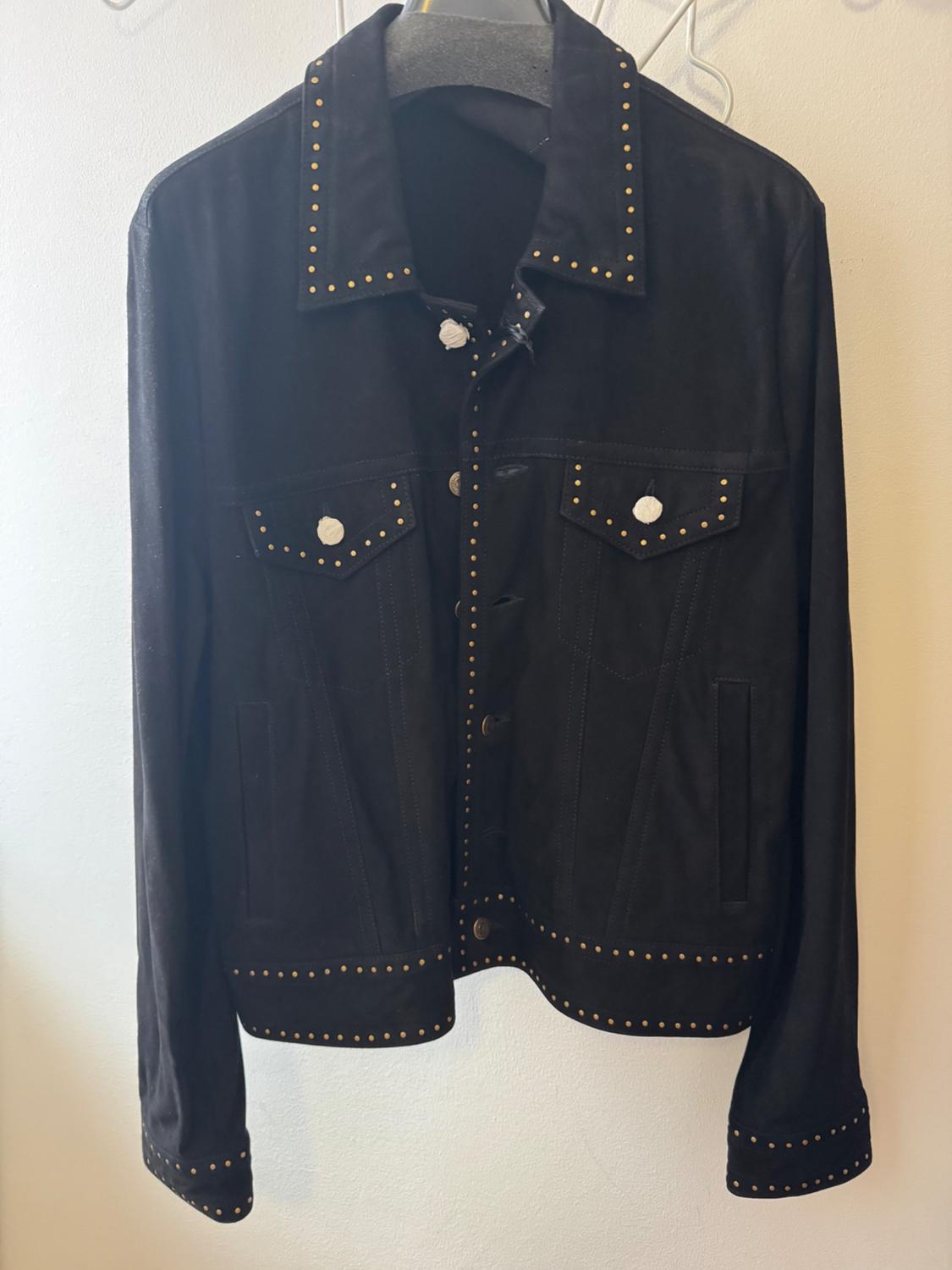 Black suede jacket with gold studs on the collar, pockets, and edges. Hanging on a hanger against a white background.