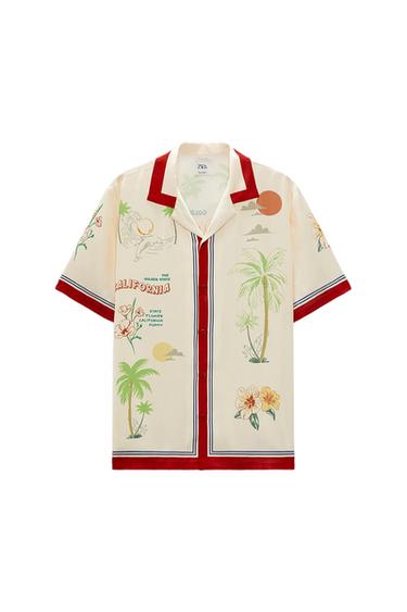 Short-sleeved shirt with a tropical palm and floral print, "California" text, cream background, and red details.