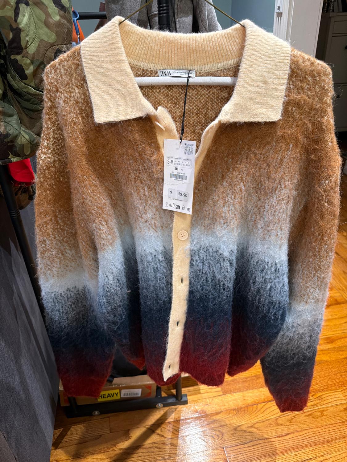 Knit cardigan with buttons and a collar, gradient design from brown to white, gray, and red. Zara label and a visible price of $59.90.
