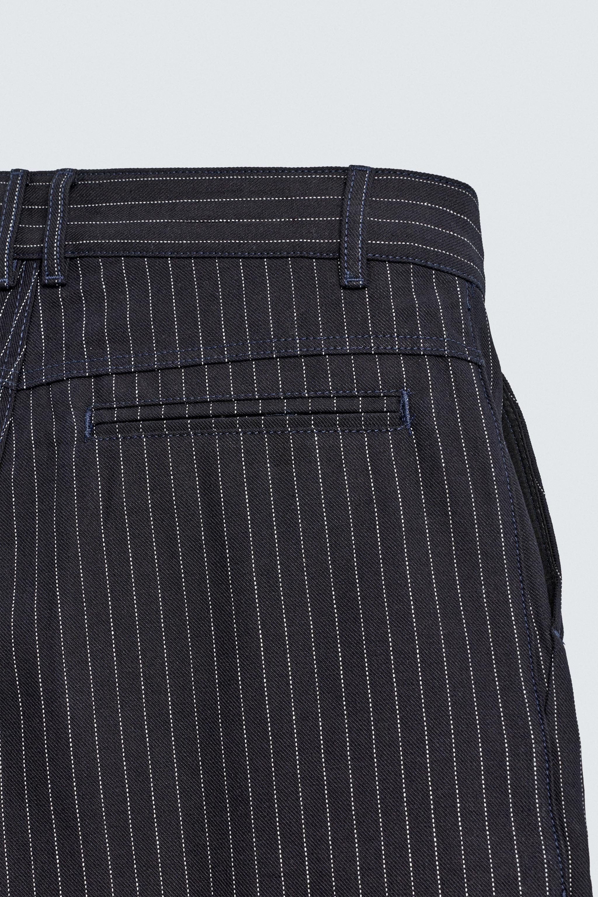 PINSTRIPED PLEATED SHORTS