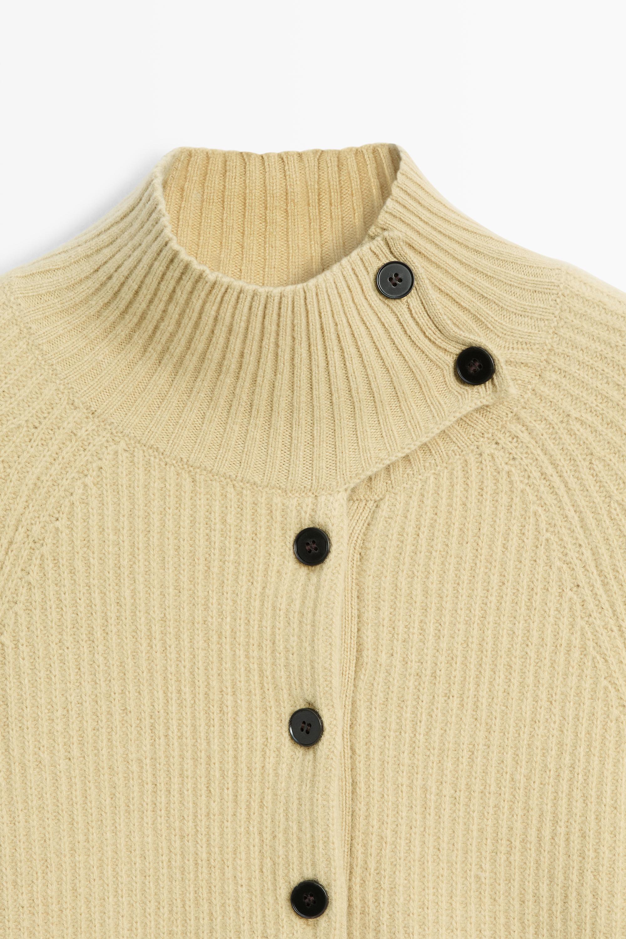 100% wool knit cape with button detail