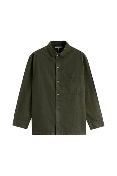 Dark green long-sleeve collared shirt with a front button closure and a patch pocket on the chest, on a white background.