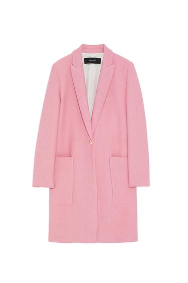 Light pink coat with lapels, large pockets, and a single-button closure. Visible interior label with "ZARA BASIC" text. White background.
