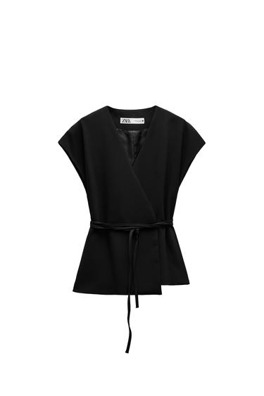 Front view of a black blouse with a belt and wide sleeves.
