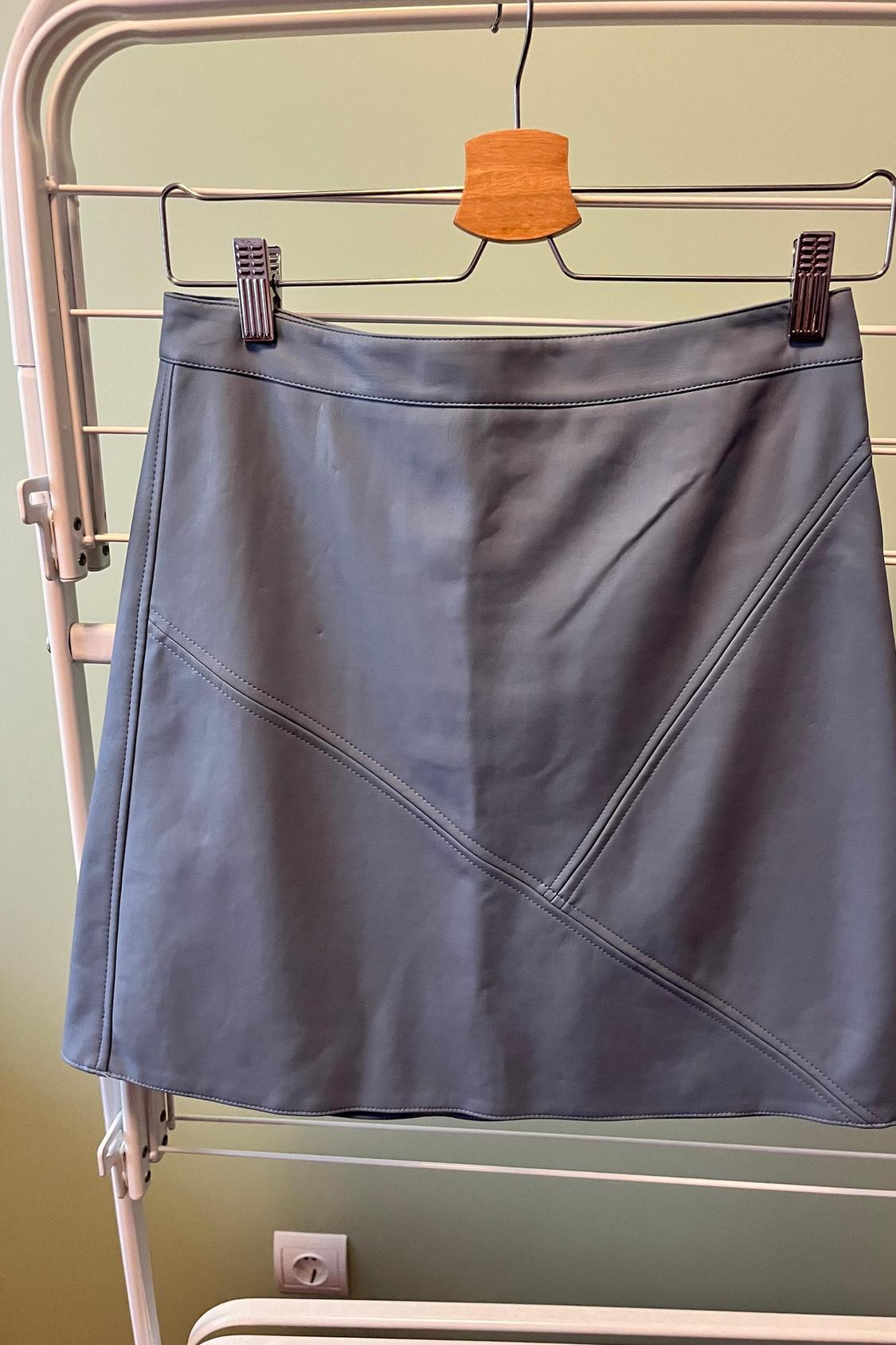 Front view of grey skirt with diagonal seams.