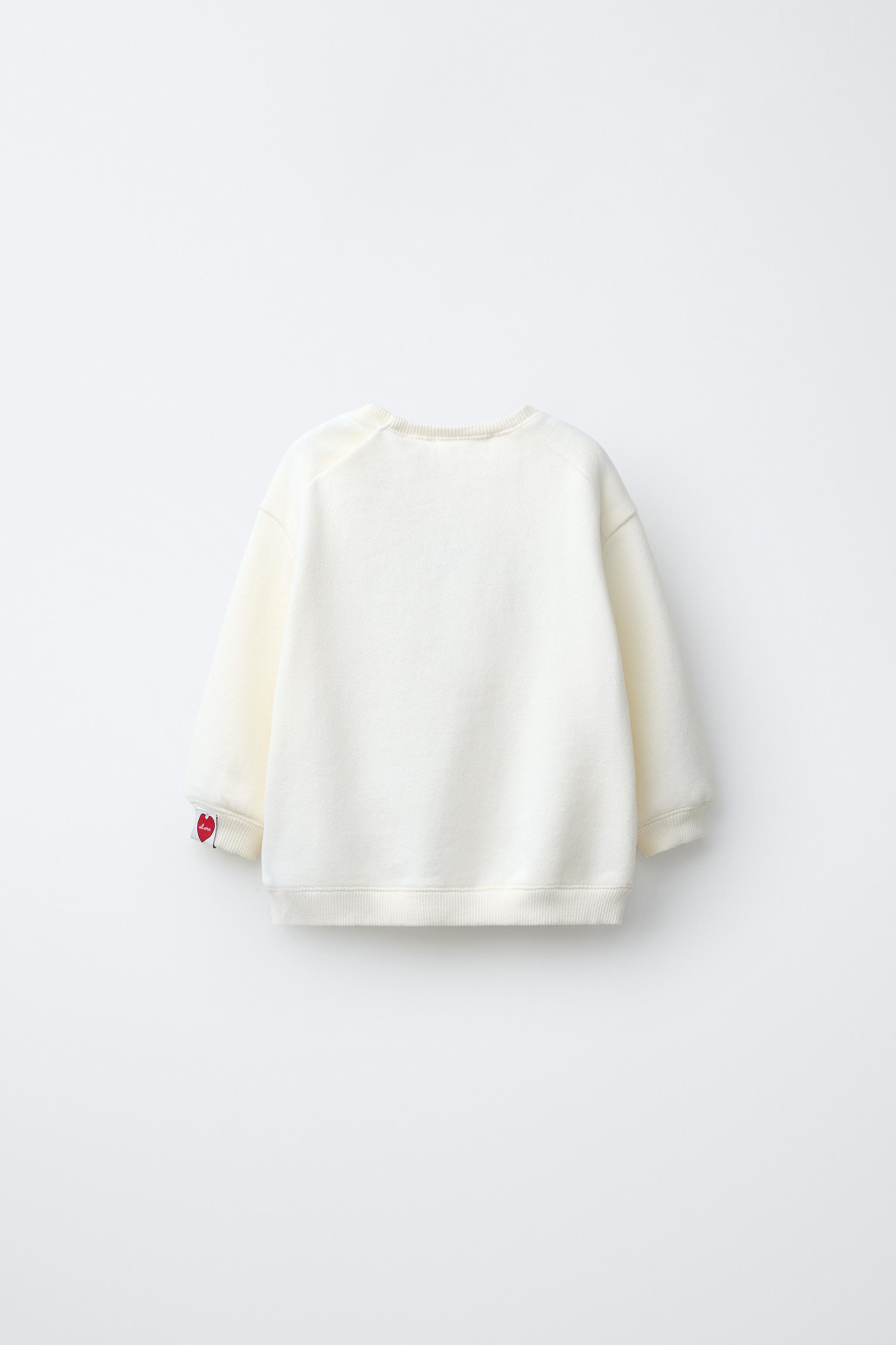 SWEAT AVEC PIÈCE VELOURS BOUCLÉ SNOOPY PEANUTS™