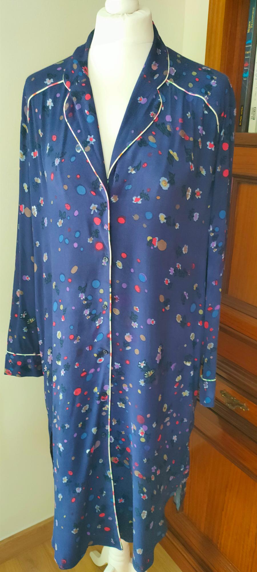 Front view of a blue dressing gown with a polka dot and floral print, white trim on the collar and sleeves.