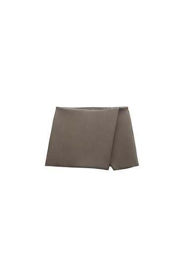 Front view of a grey mini skirt with an asymmetric design.