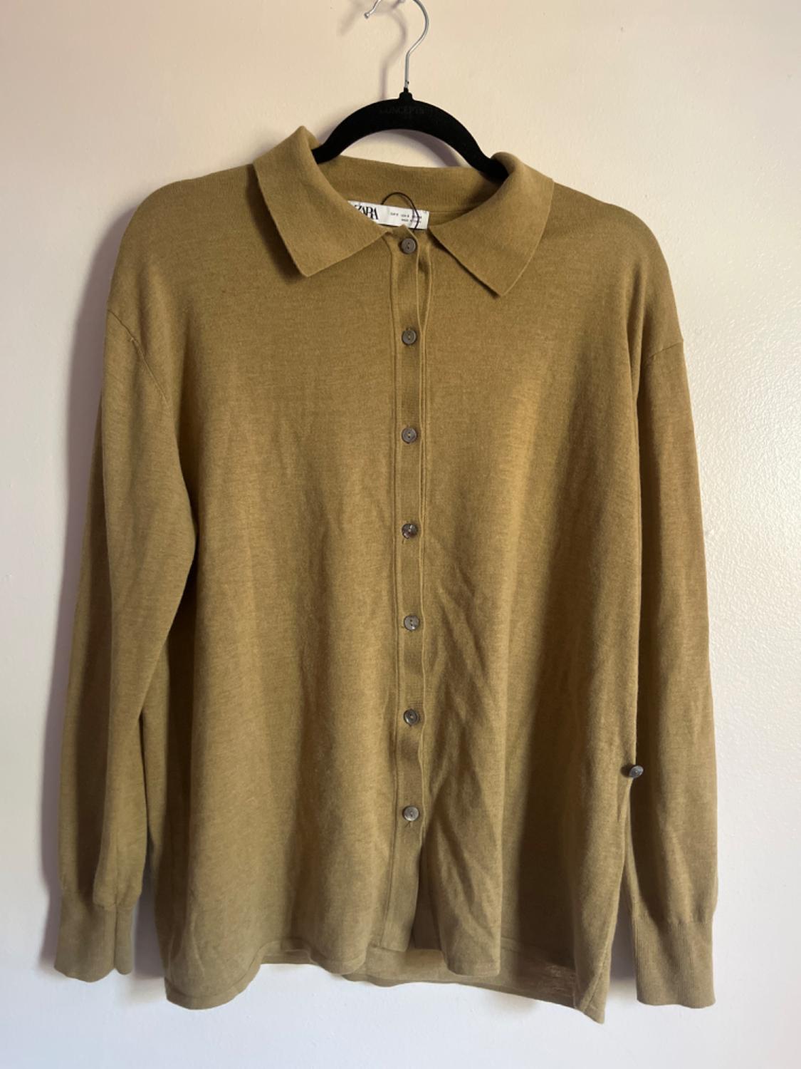 Front view of a brown shirt with a classic collar and full button placket.
