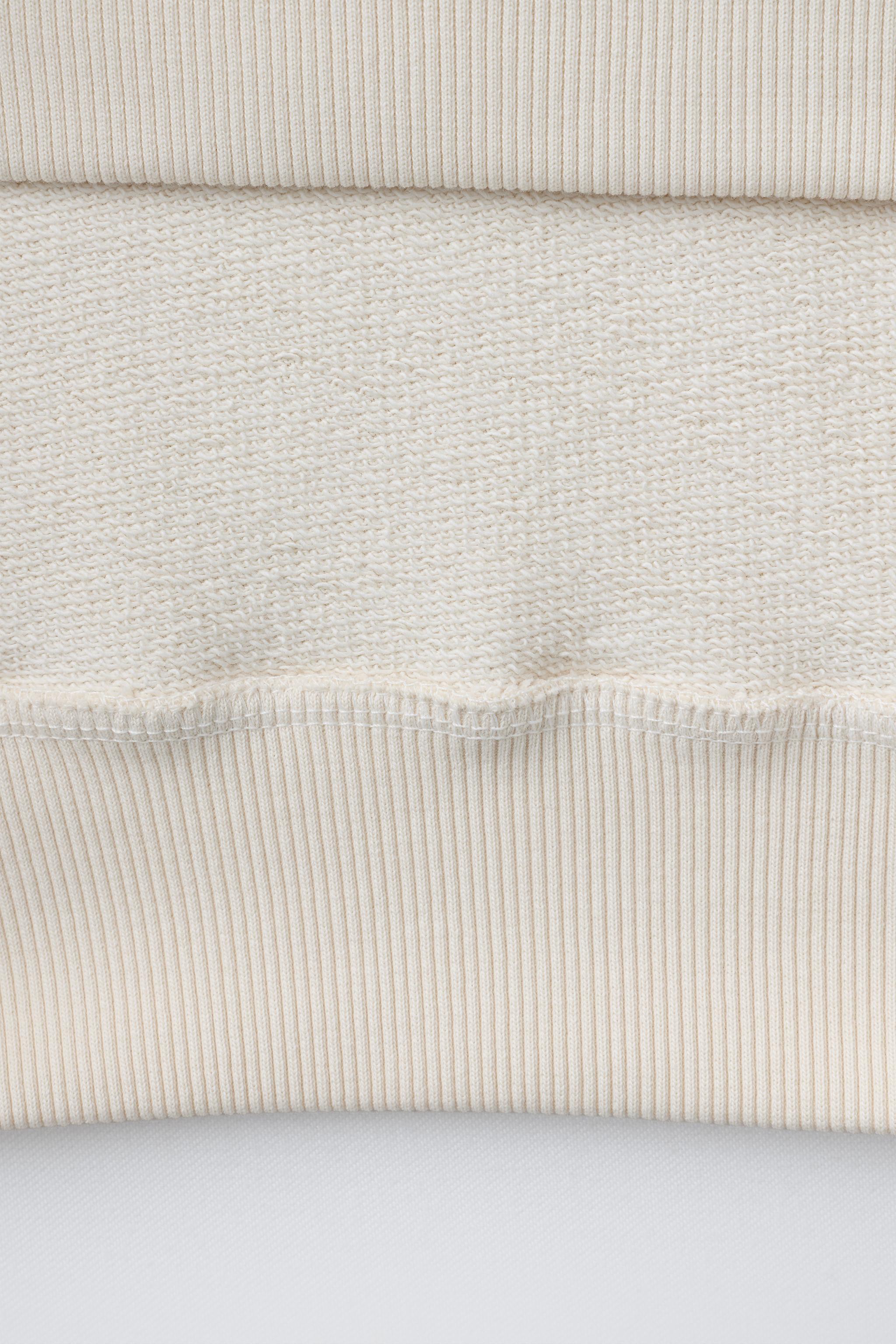 EMBROIDERED INSET SWEATSHIRT