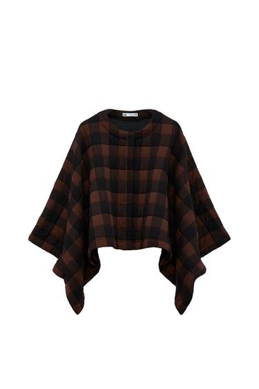 Front view of a brown and black checked poncho with a round neck and wide sleeves.