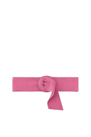 Front view of a wide pink belt with a lined oval buckle and bow detail.