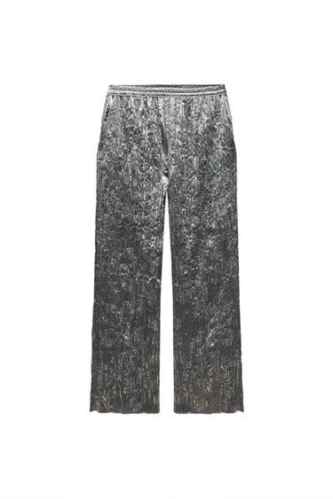 Front view of silver pants with wrinkled texture and side pockets.