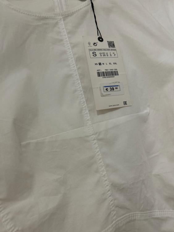 Price tag of €39.95 on a white garment with visible stitching. The tag shows size S and a barcode.
